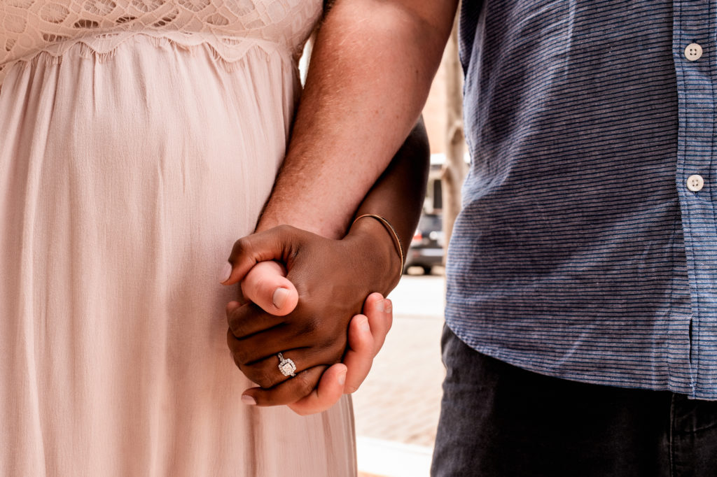 Family photographer, a man and woman hold hands